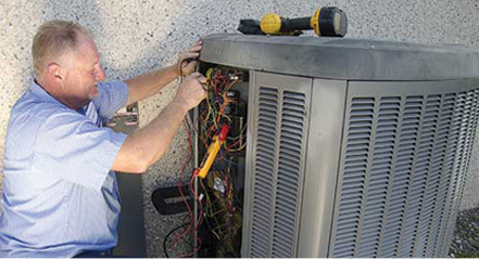 Employee working on an AC unit portraying the staff of commercial HVAC company Steve Chapman's All American Air servicing Jacksonville, FL