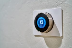 A smart thermostat mounted to a wall