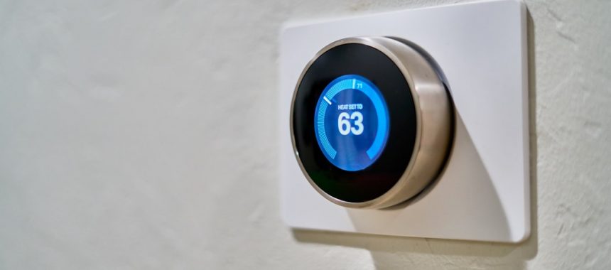 A smart thermostat mounted to a wall